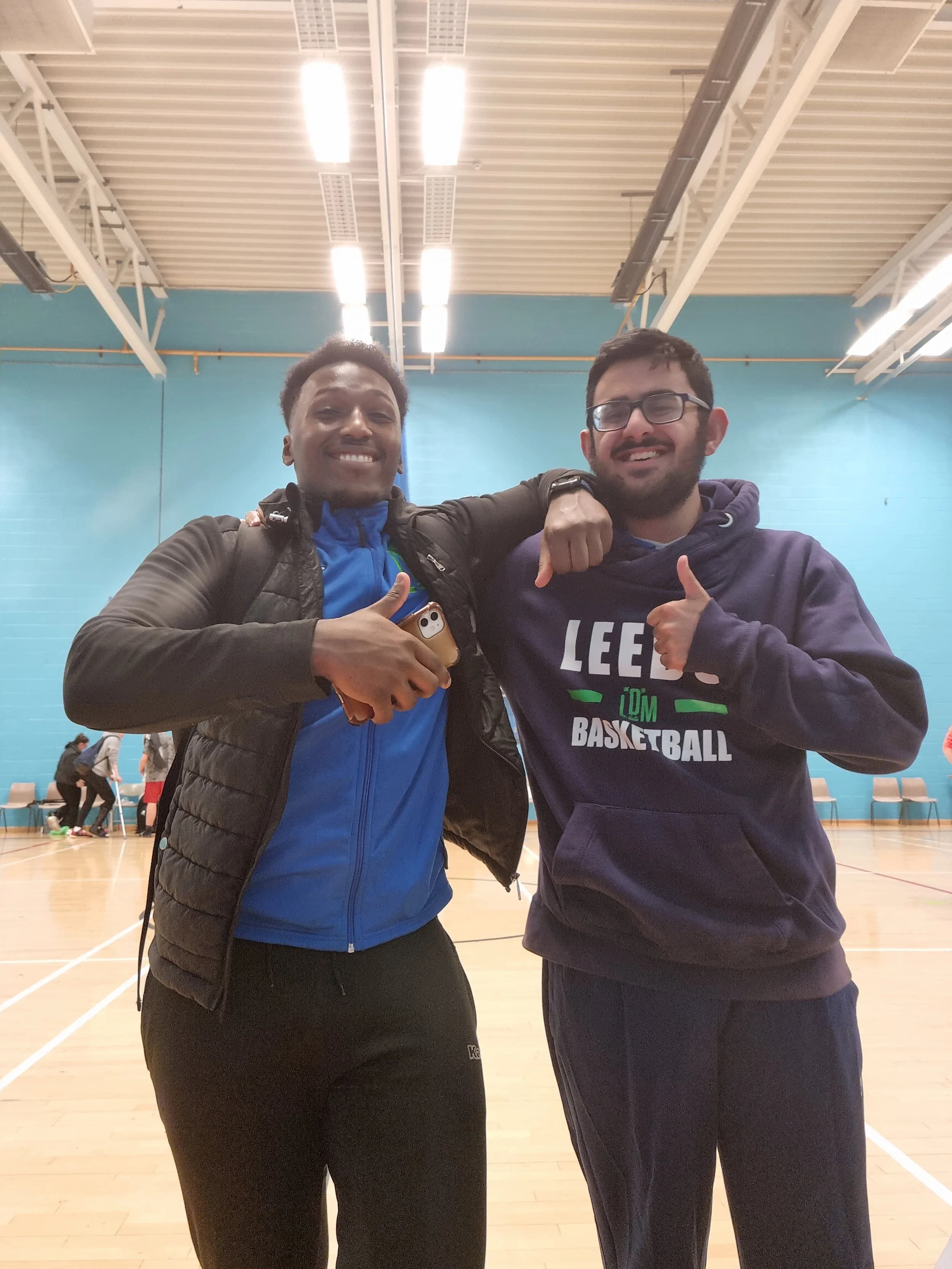 Two members of the LDM community together in a sports hall